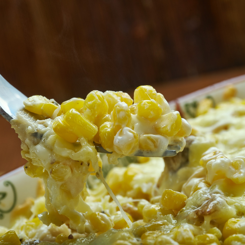 A close up of Hot Corn and Crab Dip being dished out with a spoon