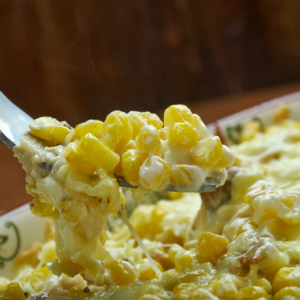 A close up of Hot Corn and Crab Dip being dished out with a spoon