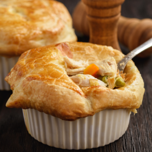 Mini Turkey Pot Pies shown up close with some vegetables peeking out the crusty top