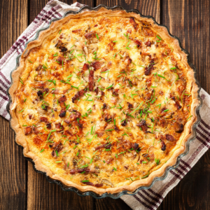 Overhead shot of a full Quiche Pie, browned and glorious
