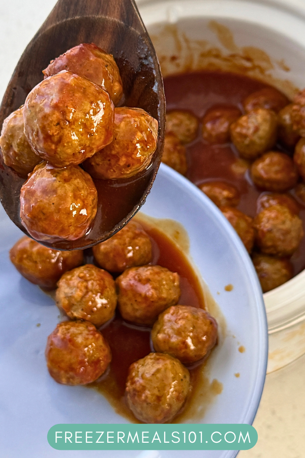 meatballs in sauce being scooped out of a slow cooker