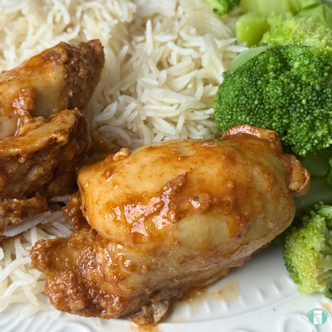 Cola Chicken on a plate with rice and broccoli