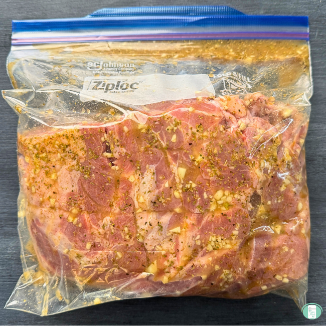 Pork shoulder marinating in the freezer quality bag.