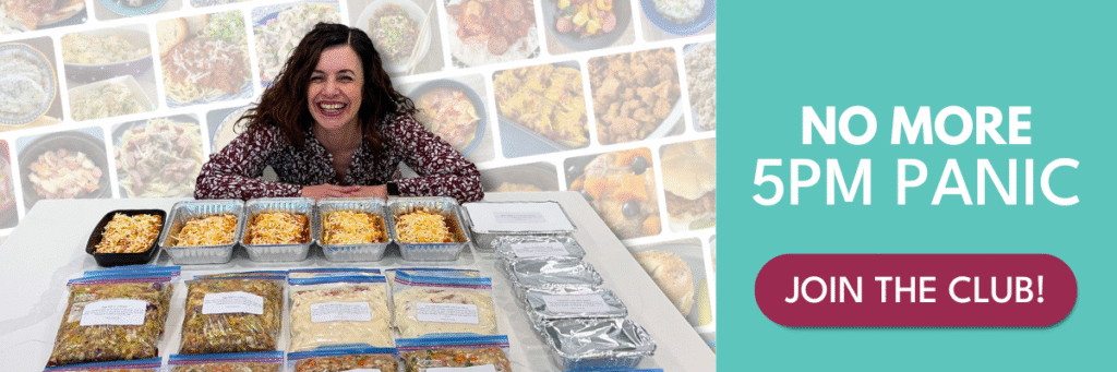 woman with many meal prep dishes in front of her on a kitchen counter