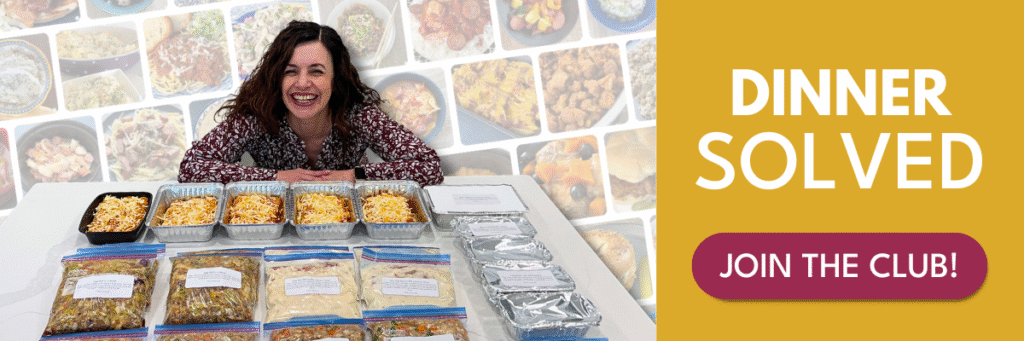woman with many individual size meal prep containers of food in front of her