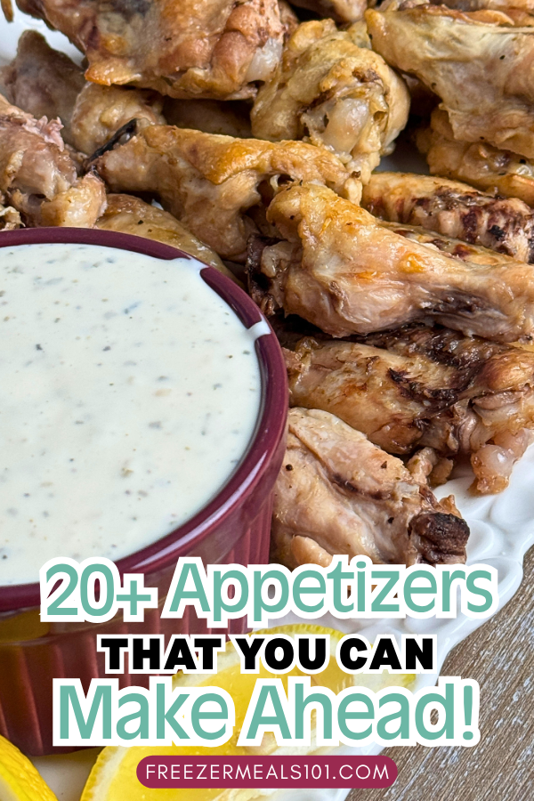 chicken wings on a platter next to some Ranch dip and lemon slices