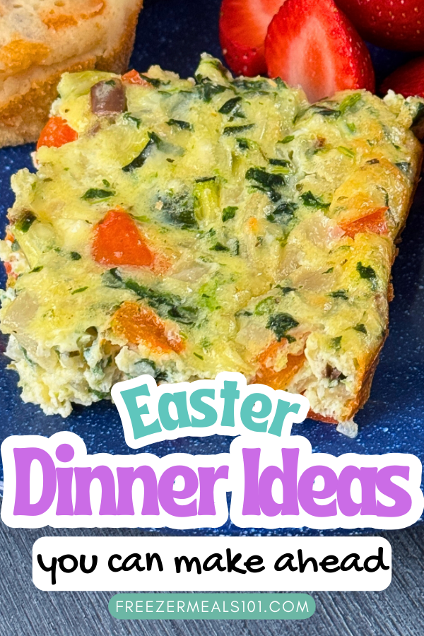 egg bake square with bits of red pepper and spinach showing on a plate next to some sliced strawberries