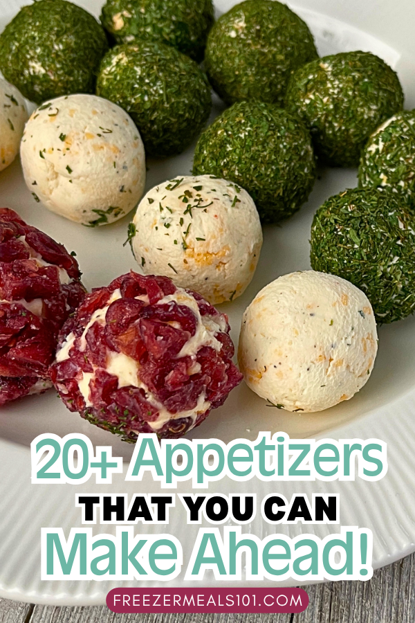 mini cheeseballs in three colors, some rolled in green herbs, some plain white and others rolled in dried cranberries