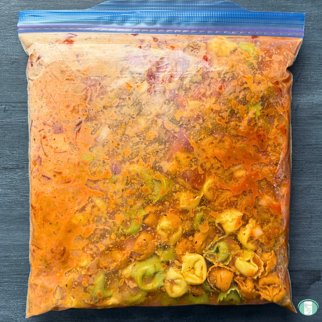 white and green tortellini in plastic freezer bag.