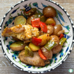 baby potatoes, peppers, and chicken in a bowl