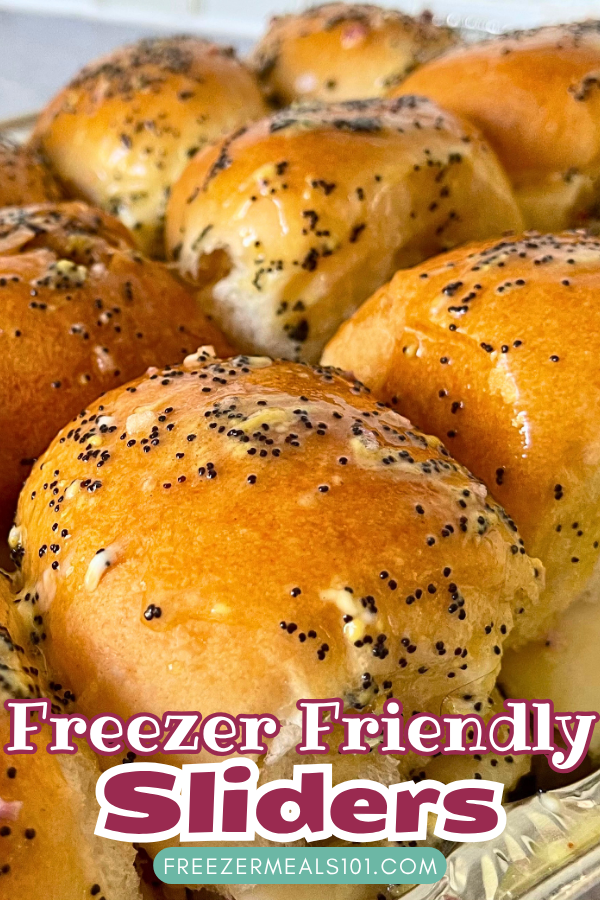 buns in a tray topped with melted butter and poppyseeds