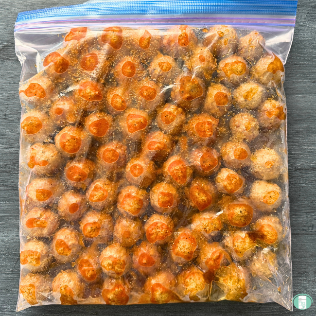 Meatballs in ziploc freezer bag with honey bourbon sauce coating them