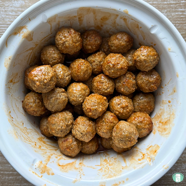 Honey bourbon meatballs in a slow cooker ready to be cooked