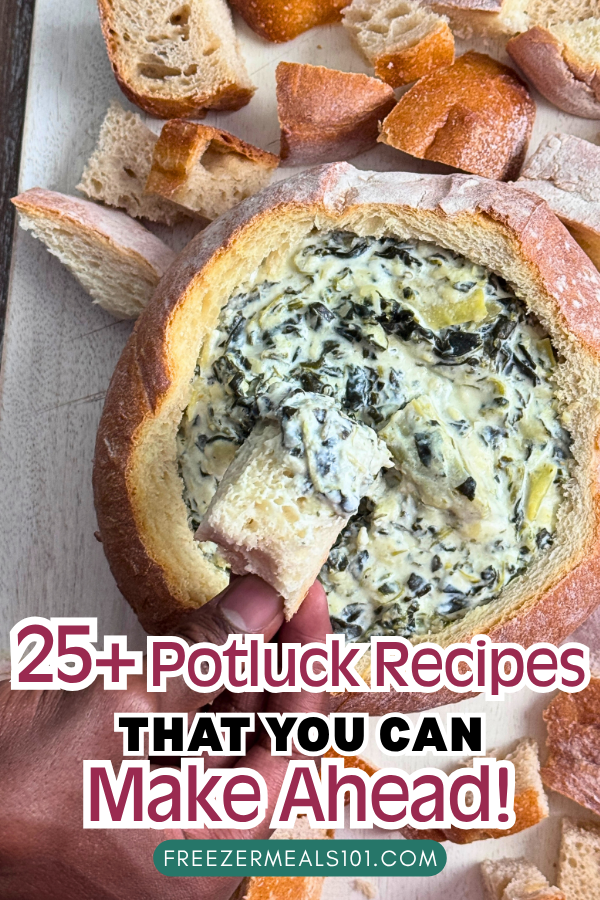 spinach and artichoke dip in a bread bowl surrounded by bread cubes