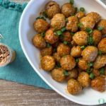 Freezer meal, slow cooker sweet and spicy meatballs served topped with green onions