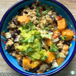 Turkey sweet potato skillet served in a bowl with avocado and cilantro on top