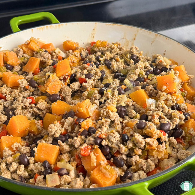 Freezer meal turkey sweet potato skillet simmering in pan, with ground turkey, black beans, sweet potatoes, and more