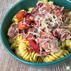 Make ahead pork roast ragu served over pasta and topped with parmesan