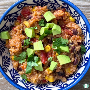 Freezer meal southwest quinoa bowl served in a bowl with cilantro and avocado on top