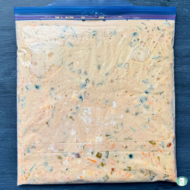 Freezer meal spicy slow cooker queso in a ziploc bag, ready to be frozen 